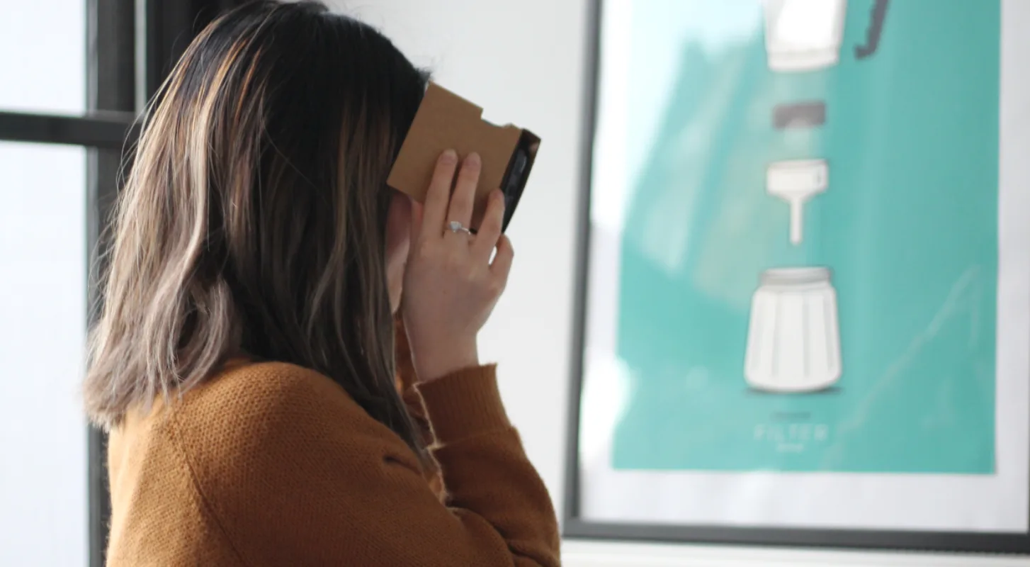 woman looking a artwork on wall - courtesy of Matthew Kwong